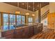 Modern kitchen with granite countertops, stainless steel appliances, dark wood cabinets and wood ceiling at 5735 Archer Ave, Cumming, GA 30041