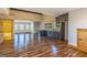 Open-concept kitchen featuring dark cabinetry with a view of the bathroom and wood floors at 5735 Archer Ave, Cumming, GA 30041