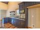 Modern kitchen with dark wood cabinets and mosaic tile backsplash at 5735 Archer Ave, Cumming, GA 30041