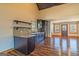 Modern kitchen featuring dark cabinetry, an island, and hardwood floors at 5735 Archer Ave, Cumming, GA 30041