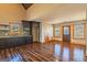 Open-concept kitchen featuring dark cabinetry and wood floors at 5735 Archer Ave, Cumming, GA 30041