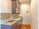 A well-organized laundry room features granite countertops and ample cabinet space for storage and convenience at 5735 Archer Ave, Cumming, GA 30041