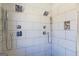 Elegant tiled shower with a dual shower head and a built-in niche for toiletries at 5735 Archer Ave, Cumming, GA 30041