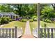 Charming backyard view from the porch steps, featuring a stone path and fountain at 35 W Main St, Hampton, GA 30228