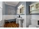 Charming bathroom featuring a classic clawfoot tub and pedestal sinks with vintage-style fixtures at 35 W Main St, Hampton, GA 30228