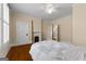 Bedroom with a four-poster bed, hardwood floors, fireplace, and shuttered windows at 35 W Main St, Hampton, GA 30228