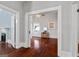 View into a light-filled room with hardwood floors and a glimpse into the room beyond at 35 W Main St, Hampton, GA 30228