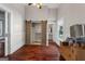 Bedroom with hardwood floors, closet with sliding barn doors, and access to ensuite bathroom at 35 W Main St, Hampton, GA 30228