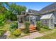 Charming home featuring a greenhouse, wooden deck, and lush landscaping perfect for enjoying the outdoors at 35 W Main St, Hampton, GA 30228