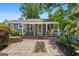 Quaint home with a charming front porch, complemented by a well-maintained yard and lush greenery at 35 W Main St, Hampton, GA 30228