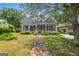 Charming two-story home with a welcoming front porch and meticulously maintained landscaping at 35 W Main St, Hampton, GA 30228