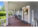 Relaxing front porch featuring a porch swing, wicker furniture, and a lovely front door at 35 W Main St, Hampton, GA 30228