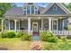 Charming two-story home with a welcoming front porch and meticulously maintained landscaping at 35 W Main St, Hampton, GA 30228