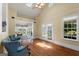 Bright living room with hardwood floors, skylights, ceiling fan and access to an adjacent room through glass doors at 35 W Main St, Hampton, GA 30228