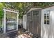Outdoor shed featuring double doors and a trellis perfect for storage and gardening needs at 35 W Main St, Hampton, GA 30228