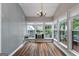 Charming sunroom featuring lots of natural light from many windows and vinyl wood-look flooring at 35 W Main St, Hampton, GA 30228