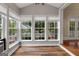Bright sunroom featuring vinyl wood-look flooring, lots of windows offering a great view, and a small chandelier at 35 W Main St, Hampton, GA 30228