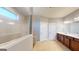 Modern bathroom featuring a glass-enclosed shower, dual sinks, and stylish fixtures at 104 Conway St, Peachtree City, GA 30269