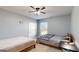 Bedroom features two beds, ceiling fan, and neutral paint at 104 Conway St, Peachtree City, GA 30269