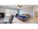 Comfortable bedroom with a ceiling fan, large windows, and carpeted floor at 104 Conway St, Peachtree City, GA 30269
