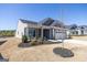 Well-maintained yard with fresh black mulch and young tree, showcasing the property's curb appeal at 104 Conway St, Peachtree City, GA 30269