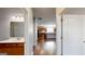 Hallway view of kitchen and bathroom with hardwood floors and neutral paint at 104 Conway St, Peachtree City, GA 30269