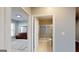 Hallway view of a bedroom and bathroom with neutral paint at 104 Conway St, Peachtree City, GA 30269