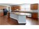 Spacious kitchen with center island, stainless steel appliances, and wood floors at 104 Conway St, Peachtree City, GA 30269
