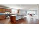 An open-concept kitchen features wood cabinets and an island at 104 Conway St, Peachtree City, GA 30269