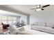 Bright living room featuring neutral colors, hardwood floors, and a ceiling fan at 104 Conway St, Peachtree City, GA 30269