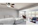 Inviting living room with neutral walls, modern ceiling fan, and views into a bright sunroom at 104 Conway St, Peachtree City, GA 30269
