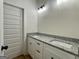 Bathroom vanity features double sinks, granite countertop, and white shaker cabinets at 6149 Se Pinewood Dr, Covington, GA 30014
