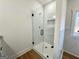 Sleek bathroom with glass-enclosed shower, white tile and modern fixtures at 6149 Se Pinewood Dr, Covington, GA 30014