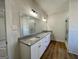 Well-lit bathroom with double vanity, granite countertops, and a glass-enclosed shower at 6149 Se Pinewood Dr, Covington, GA 30014