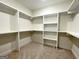 Spacious walk-in closet with custom shelving for optimal organization at 6149 Se Pinewood Dr, Covington, GA 30014