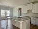 Spacious kitchen featuring white cabinets, granite countertops, and stainless steel appliances at 6149 Se Pinewood Dr, Covington, GA 30014