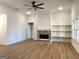 Comfortable living room with a cozy brick fireplace and floating shelves at 6149 Se Pinewood Dr, Covington, GA 30014