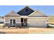 Charming home features a two-car garage and a beautifully designed gray exterior, enhancing its curb appeal at 435 Cantrell Drive, Dallas, GA 30157