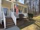 Inviting covered front porch featuring classic white railings and wooden stairs at 22 Moonlight Se Drs, Acworth, GA 30102