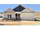 Charming home features a two-car garage, beautiful stonework, and an inviting front porch at 481 Cantrell Drive, Dallas, GA 30157
