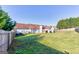 Fenced backyard featuring a lush lawn, a patio and mature trees at 39 Thorne Berry Dr, Hampton, GA 30228