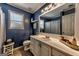 Stylish bathroom with a large mirror, blue walls, and white vanity providing ample counter space at 39 Thorne Berry Dr, Hampton, GA 30228