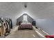 Attic bedroom with sloped ceiling, closet space, and natural light at 39 Thorne Berry Dr, Hampton, GA 30228