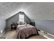 Attic bedroom with sloped ceiling, and natural light from a window at 39 Thorne Berry Dr, Hampton, GA 30228