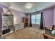 Spacious bedroom with carpeted floor, large window, and a built-in bookcase at 39 Thorne Berry Dr, Hampton, GA 30228