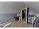 Attic bedroom with sloped ceiling, closet space, and natural light at 39 Thorne Berry Dr, Hampton, GA 30228