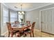 Cozy dining area featuring a round table, chandelier, and ample natural light at 39 Thorne Berry Dr, Hampton, GA 30228