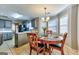 Cozy dining area features a round table, chandelier, and tiled floor and kitchen views at 39 Thorne Berry Dr, Hampton, GA 30228