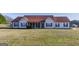 Charming single-story home with a well-manicured lawn and inviting covered front porch at 39 Thorne Berry Dr, Hampton, GA 30228