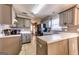 Beautiful kitchen with gray cabinets, sleek appliances, and a view of the living room fireplace at 39 Thorne Berry Dr, Hampton, GA 30228
